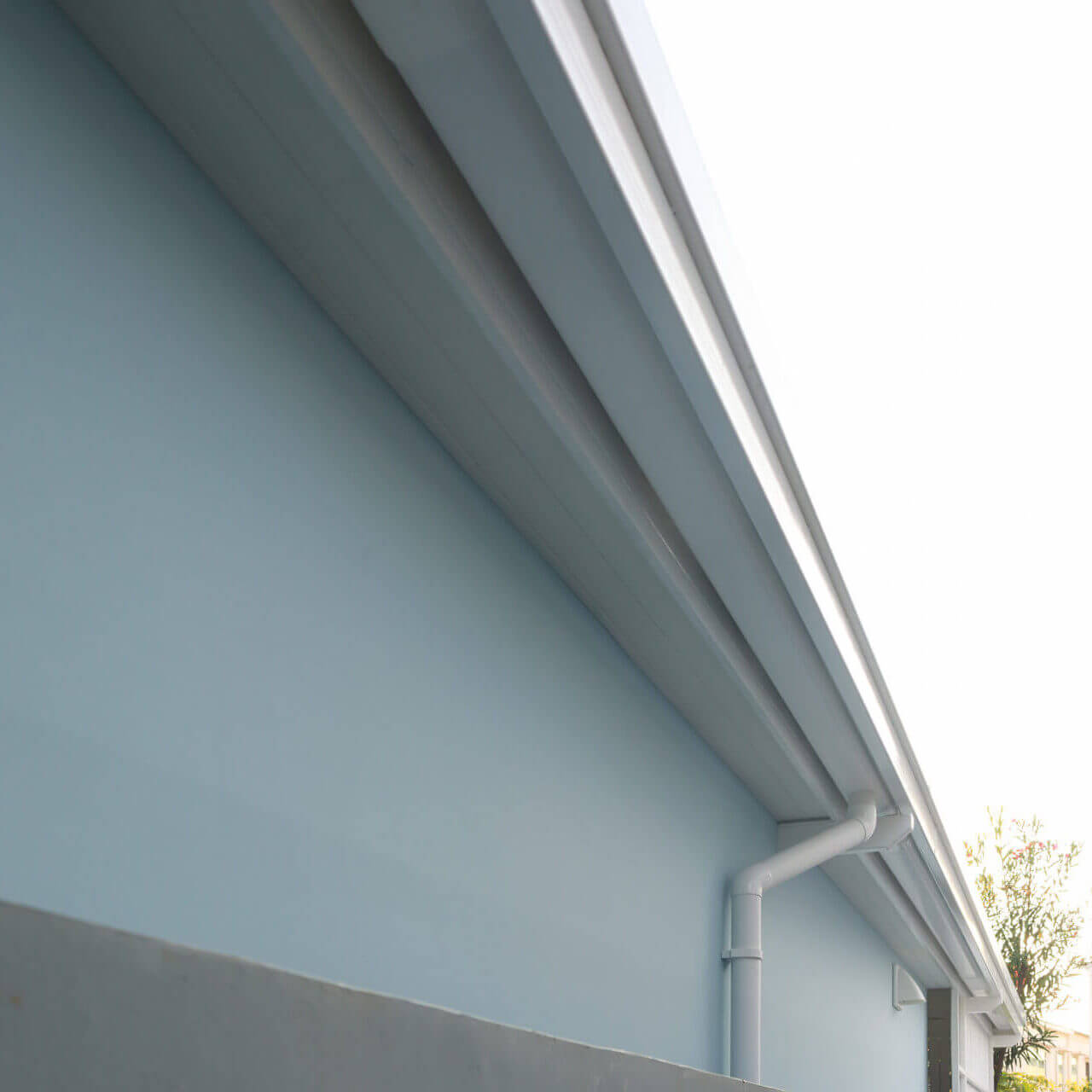 Rain Gutter Install On Steel Structure, Connect To Pvc Downpipe Or Downspout, Elbow At Eaves, Exterior House Building. Also Called Guttering Or Eavestrough For Water Drainage System. Look New Clean.